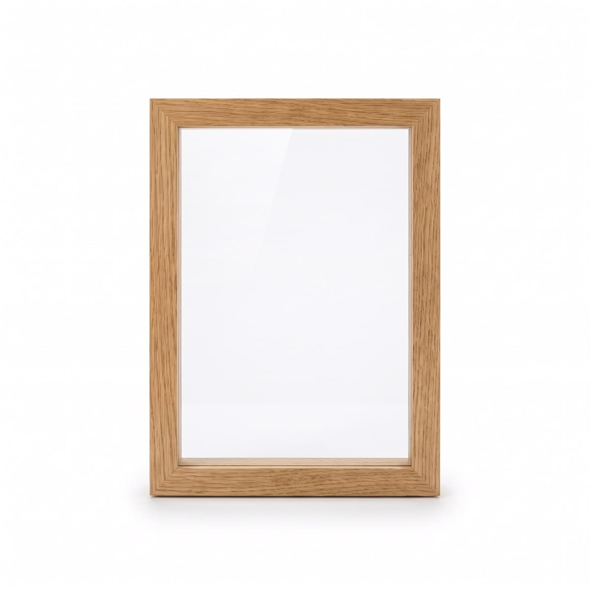 An empty oak photo frame with a clear glass front, standing upright in portrait