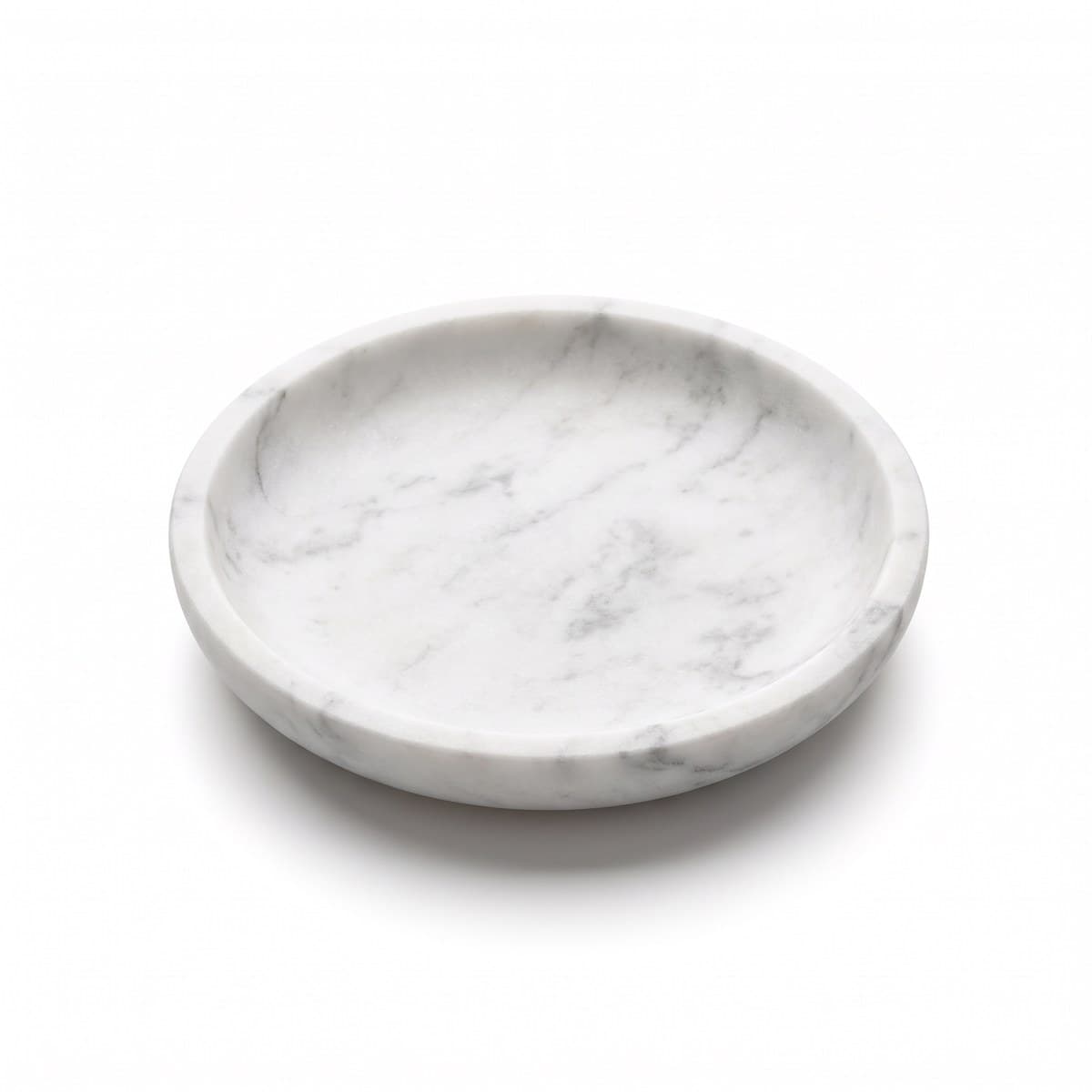 A shallow round white marble dish with grey veining, empty